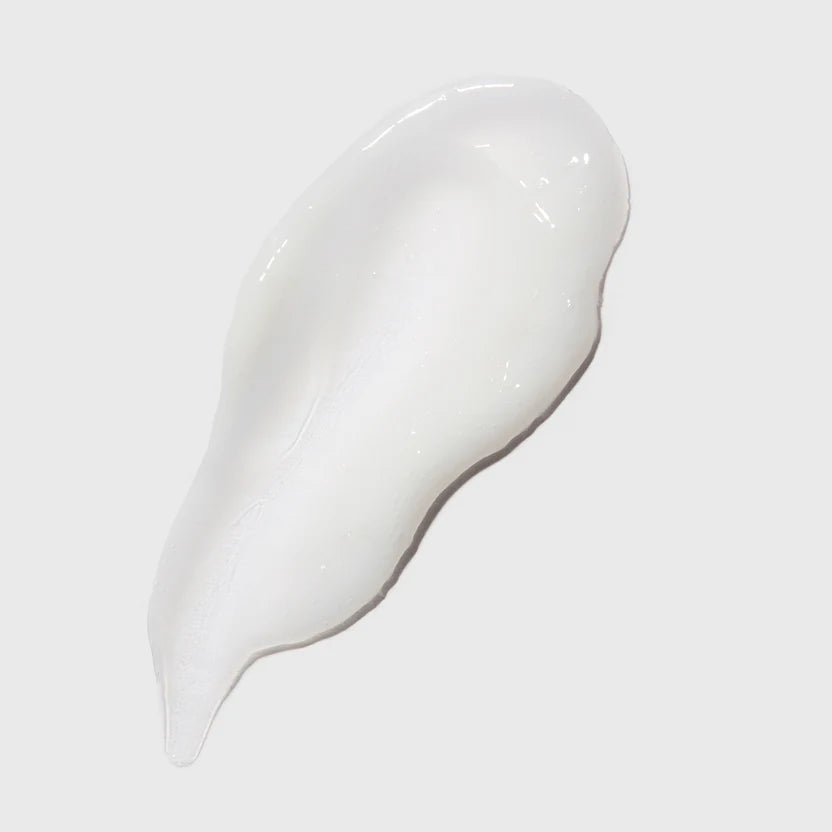 White cream or gel on a gray background