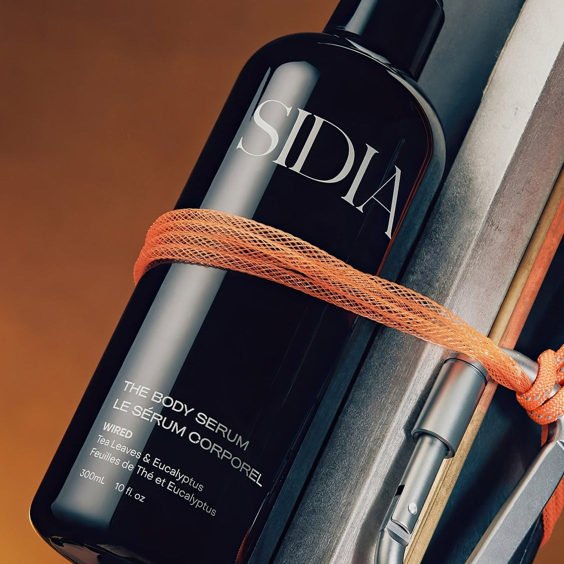 Black Sidia bottle with a spray nozzle on a wooden surface