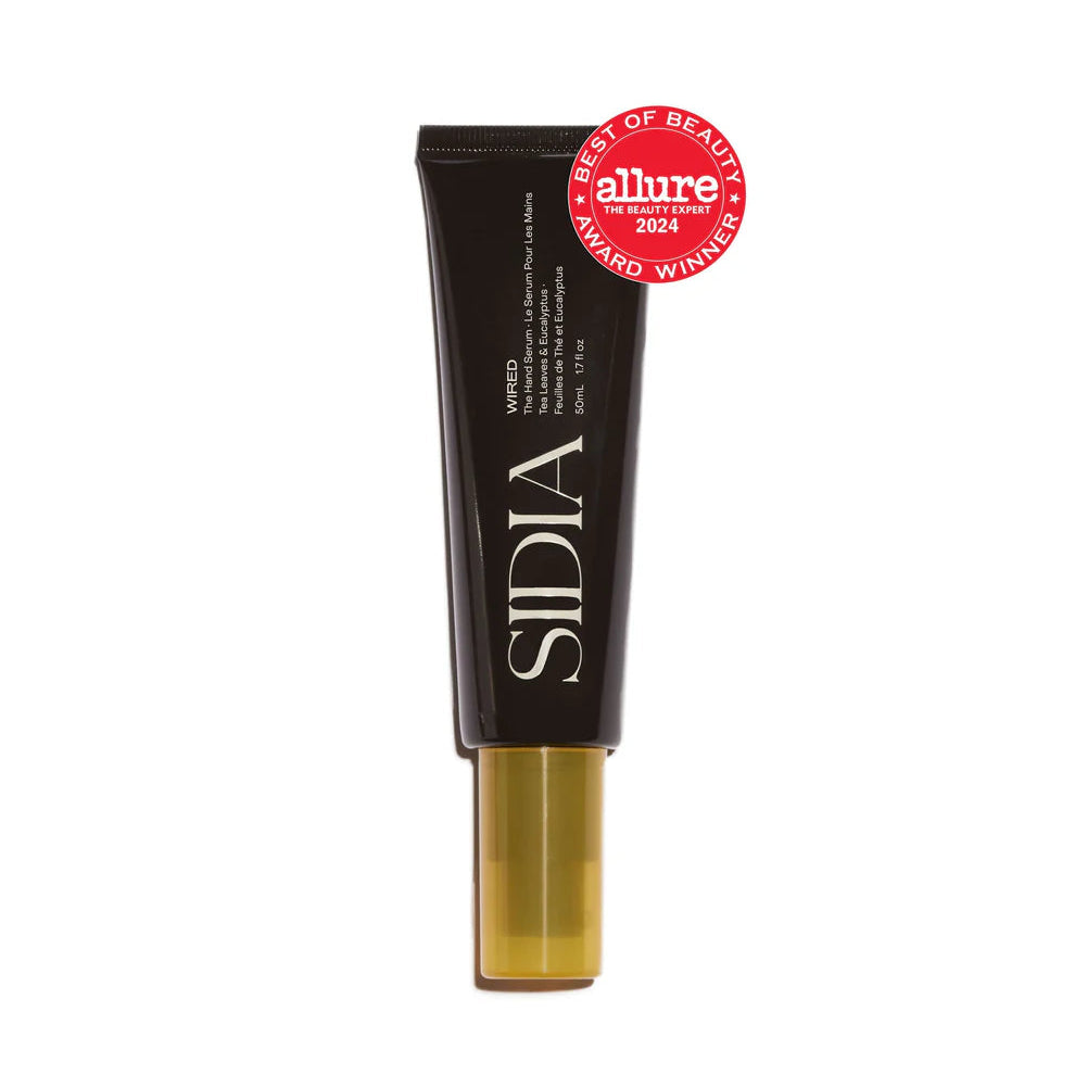 Black cosmetic tube with gold base on a white background