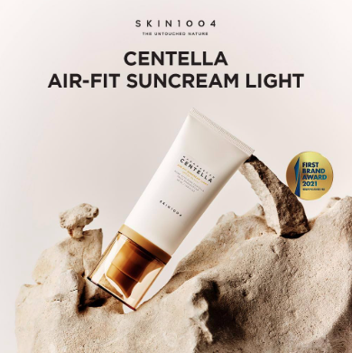 Centella air-fit suncream light tube on a rock with 'Skin1004' branding.