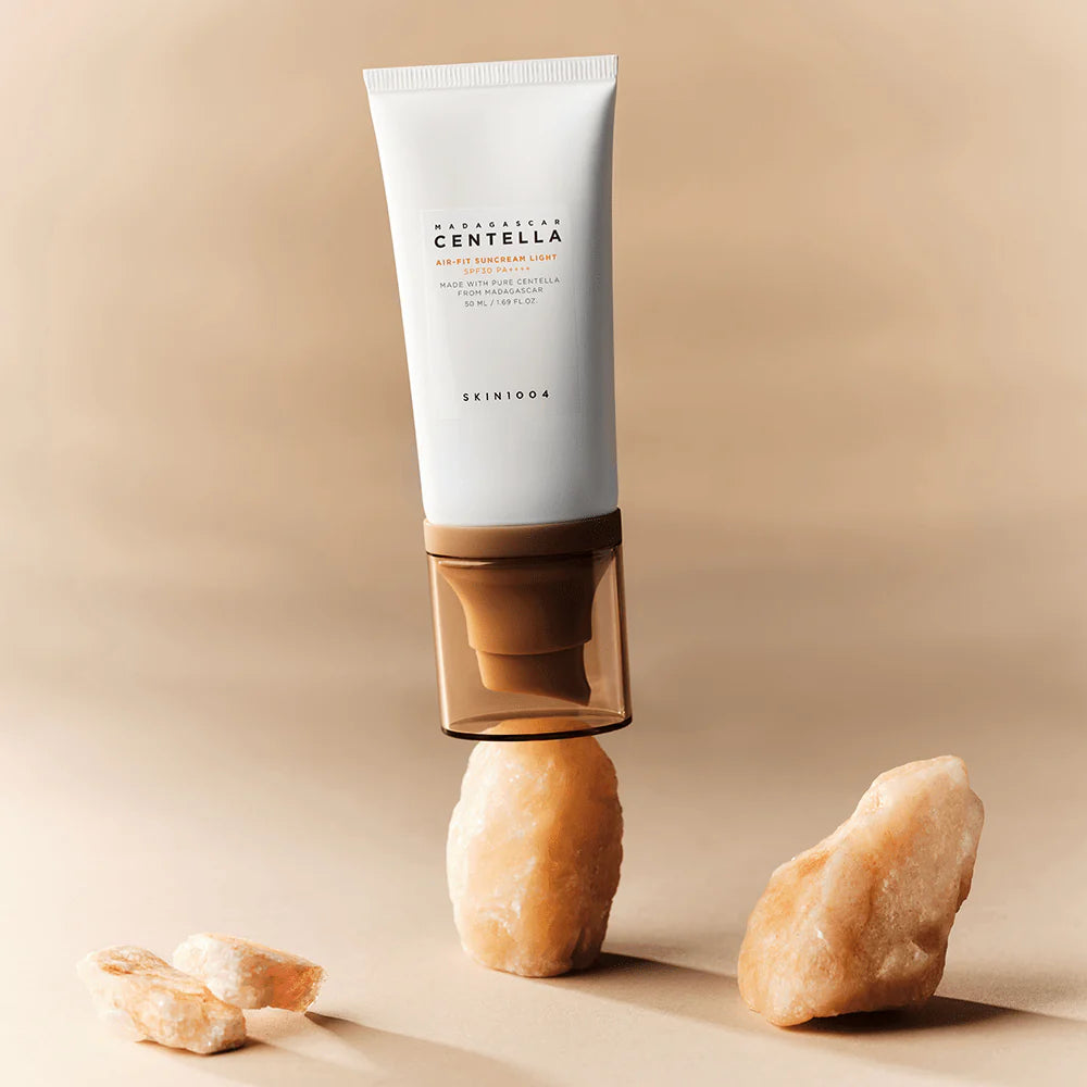 Skincare product with a natural stone and plant on a beige background
