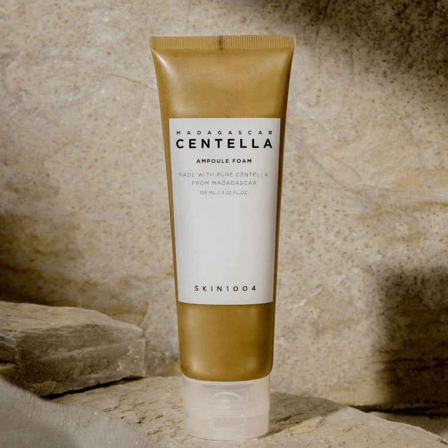 Skincare product tube labeled 'Madagascar Centella' on a stone background