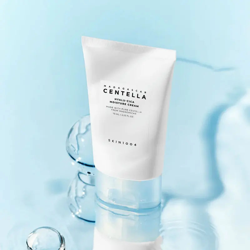 Skincare tube labeled 'Madagascan Centella' on a light blue background
