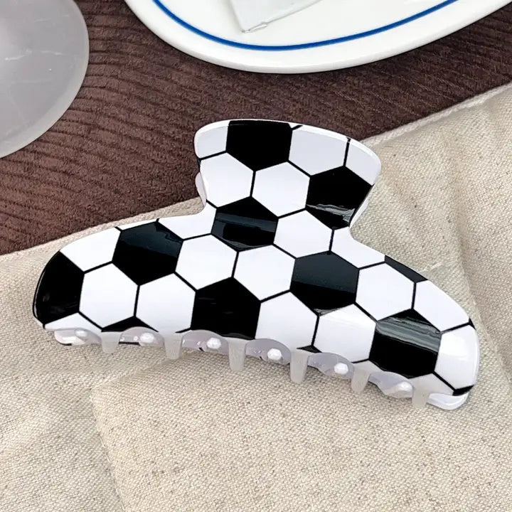 Black and white checkered shoe on a beige surface