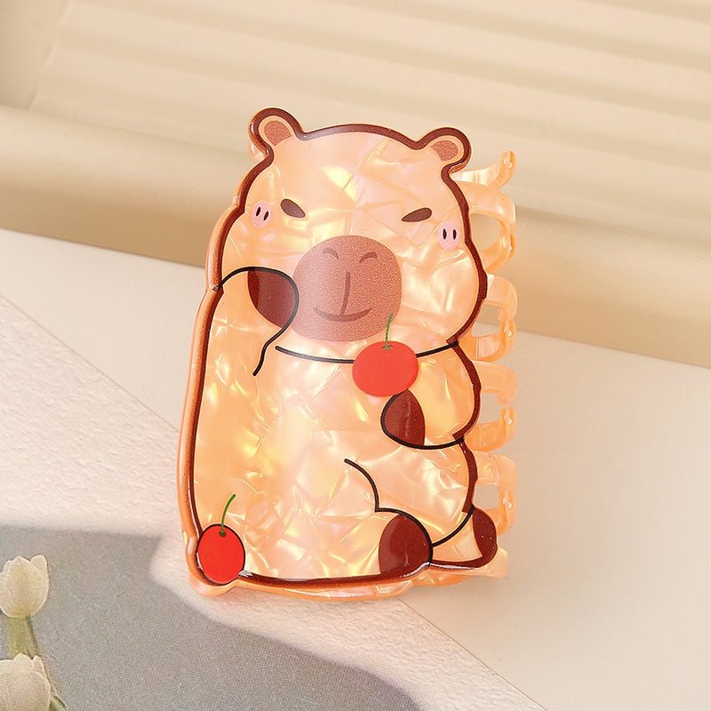 Cute bear-shaped night light with string lights on a soft surface.