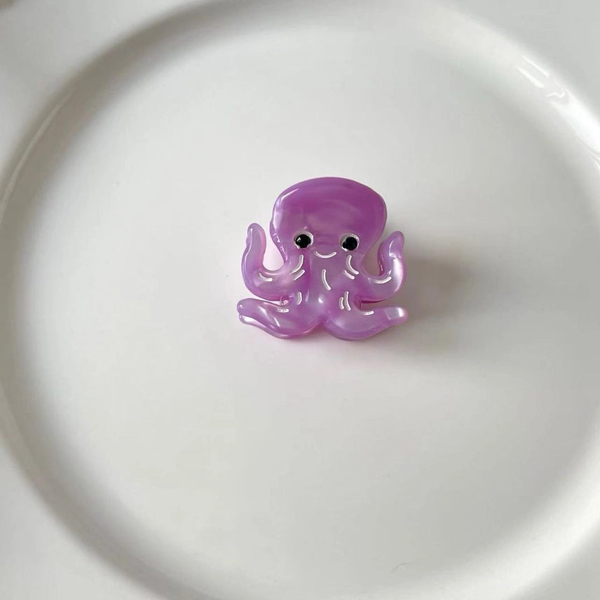 Purple octopus toy on a white background