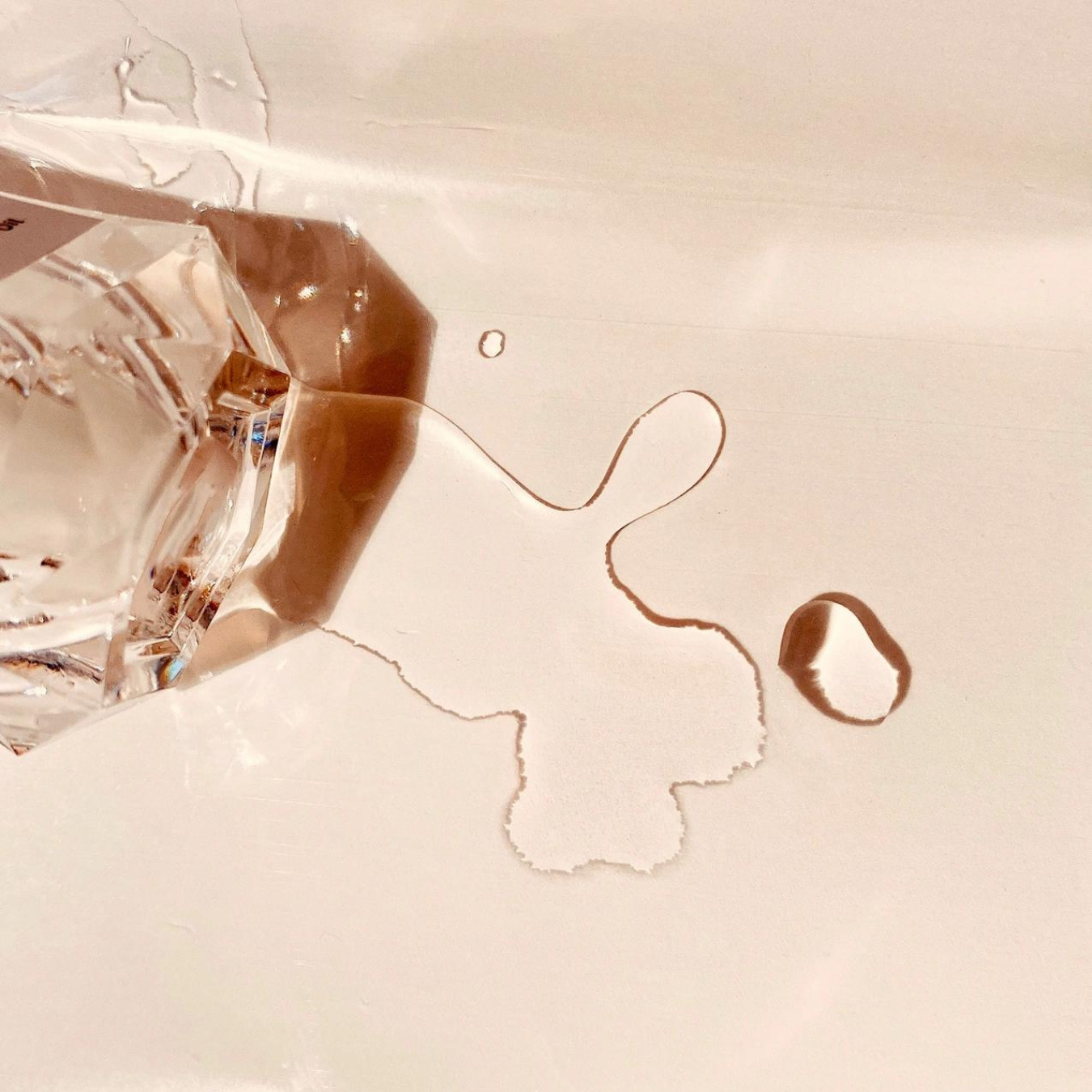 Close-up of a diamond with a cracked surface on a beige background