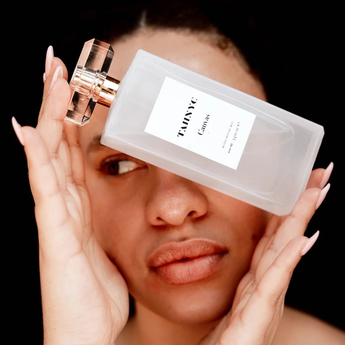 Beauty model showcasing TAHNYC Canvas Active Peptide Mist at The Pharmacy Lab for luminous and healthy-looking skin