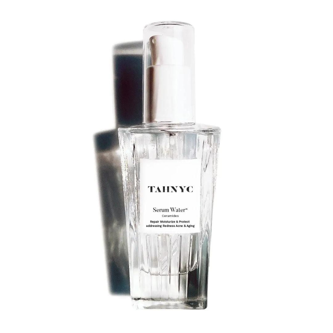 Clear serum bottle with silver cap on a white background