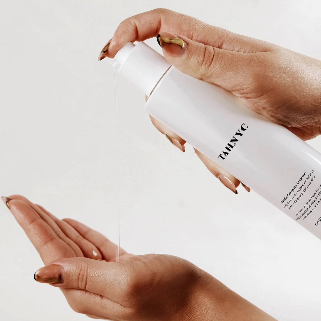 White bottle with 'Tah NYC' branding on a white background