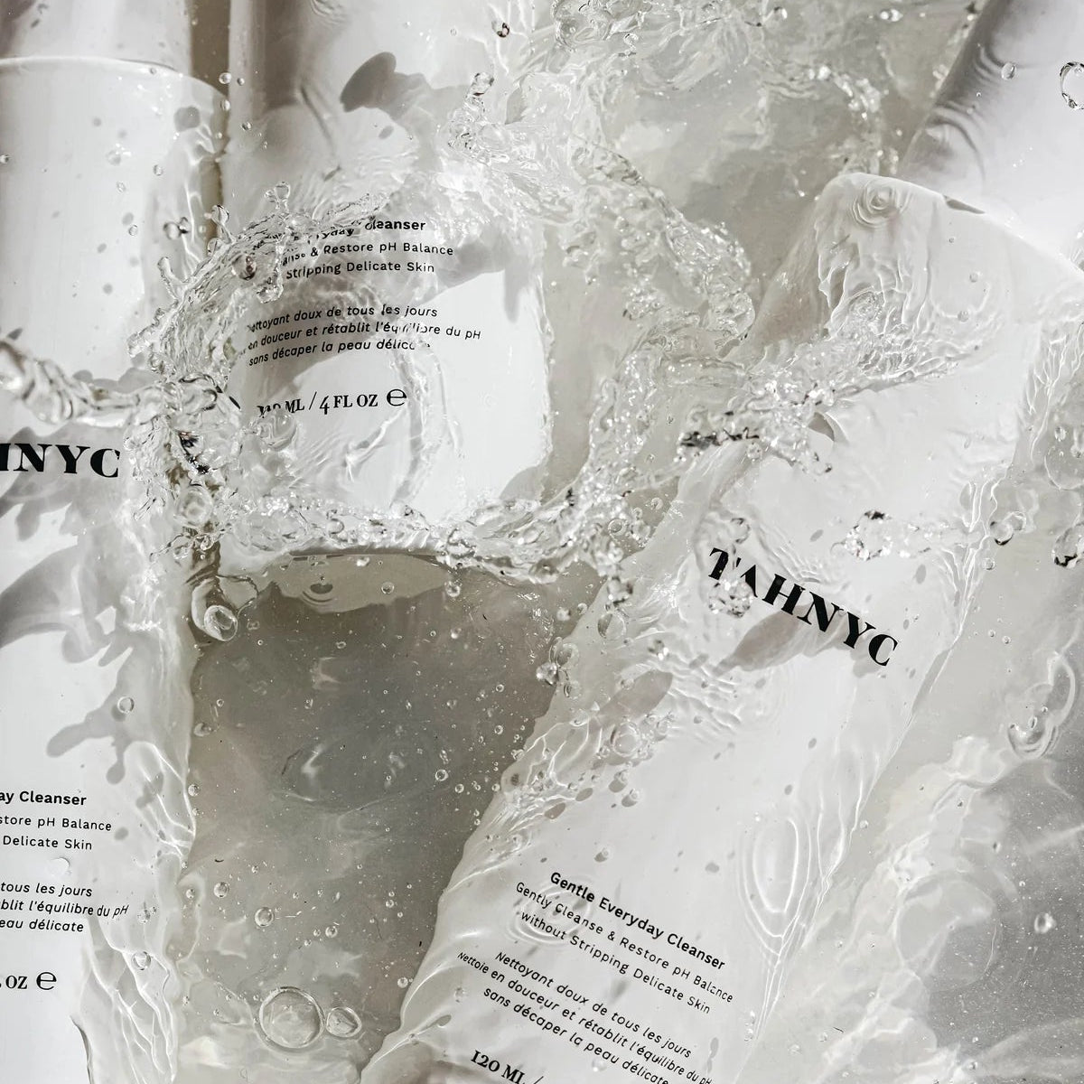 Tah NYC skincare products in a water droplet effect