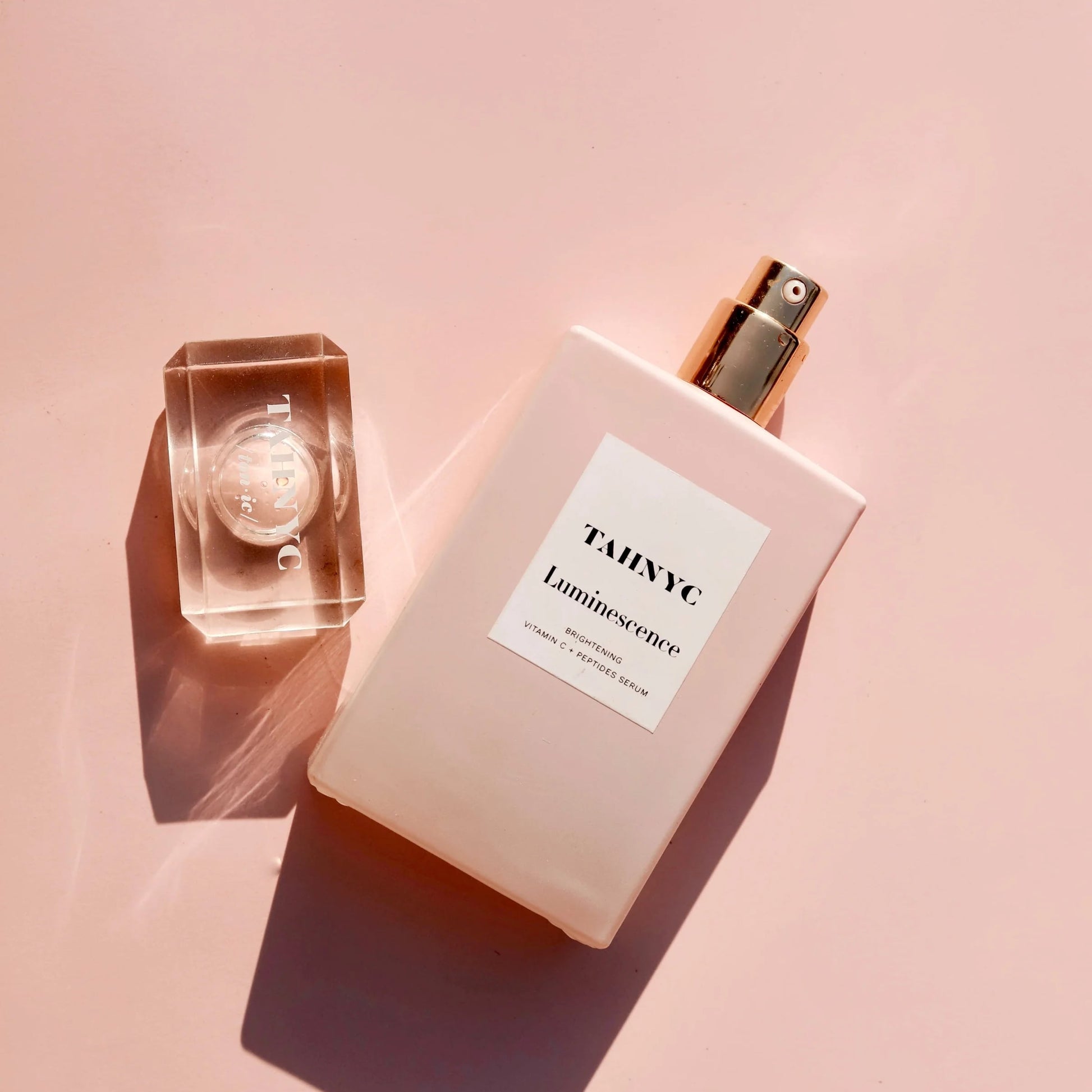 TAHNYC Luminescence Vitamin C + Peptides Serum flatlay with crystal cap and soft blush background – The Pharmacy Lab