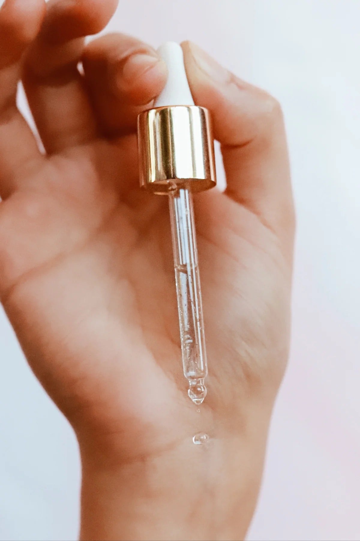 Hand holding dropper with TAHNYC niacinamide serum formula – The Pharmacy Lab