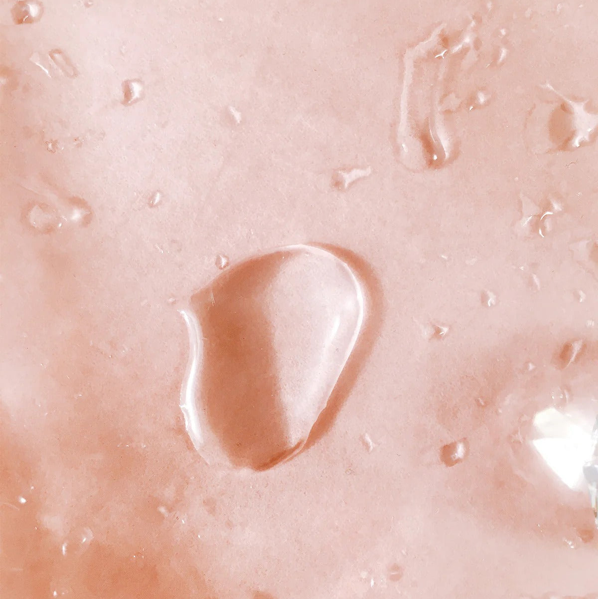 Water droplets on blush surface symbolizing hydration and clarity – The Pharmacy Lab