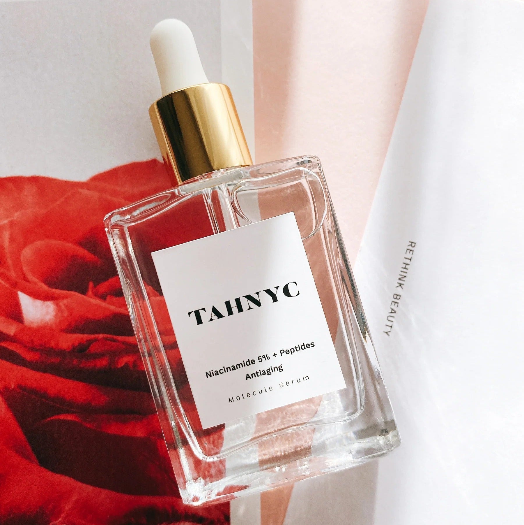 TAHNYC Niacinamide 5% + Peptides Serum bottle in back pocket of jeans for lifestyle shot – The Pharmacy Lab