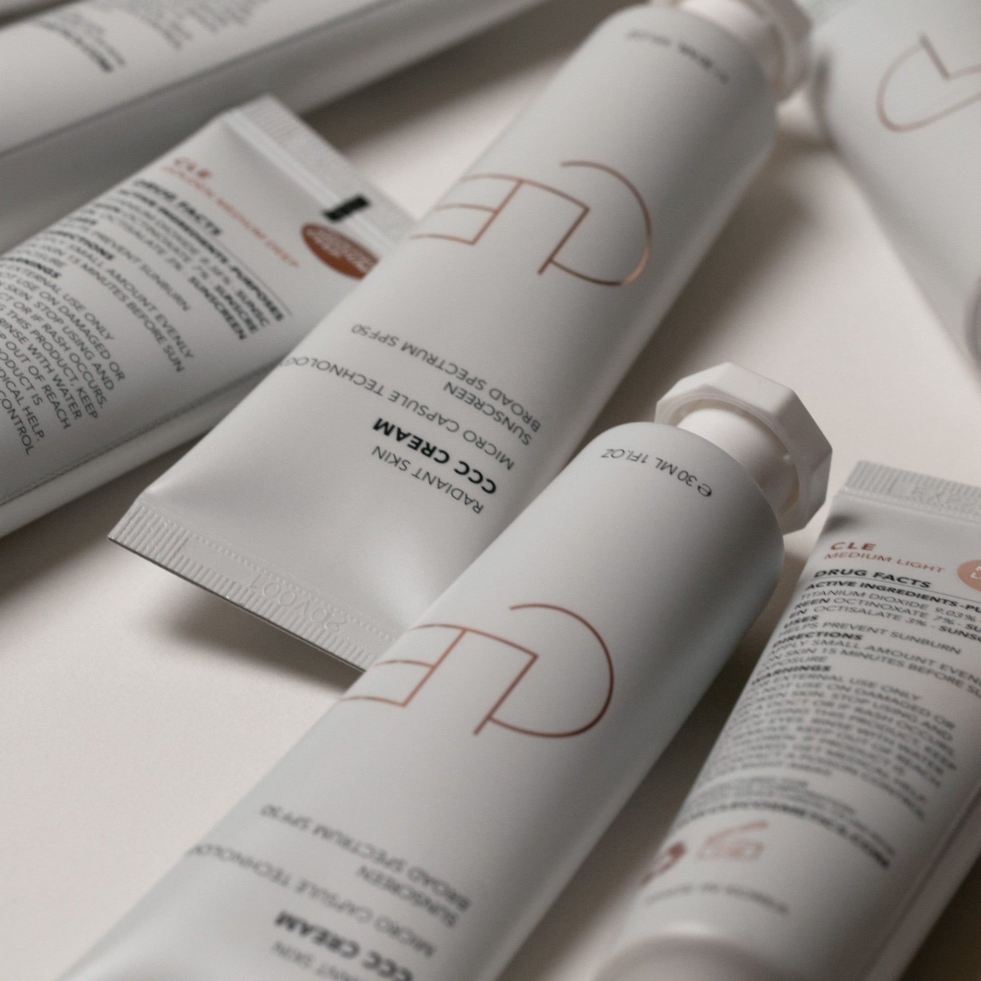 Cosmetic products with visible brand logo on a light background