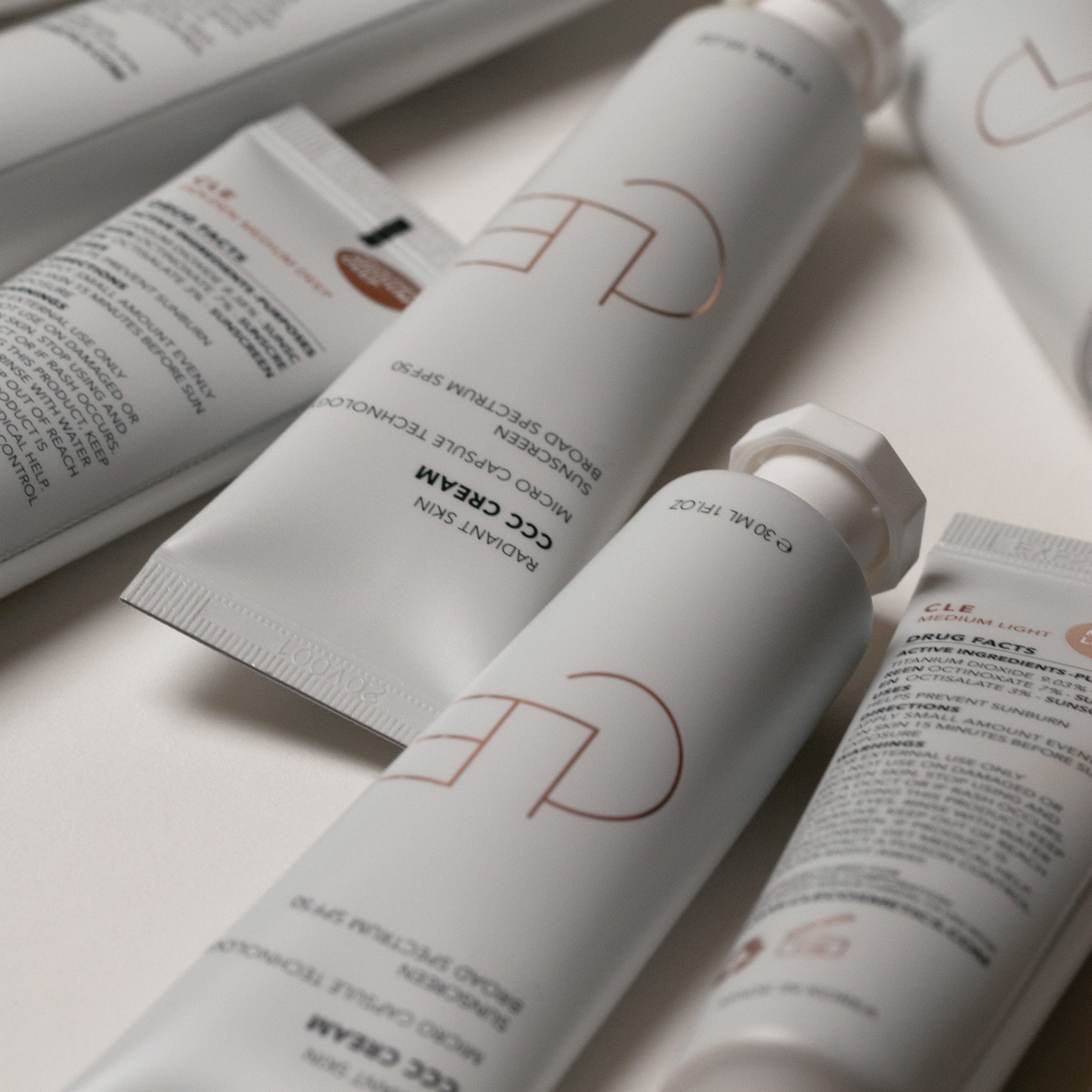 Cosmetic products with visible brand logo on a light background