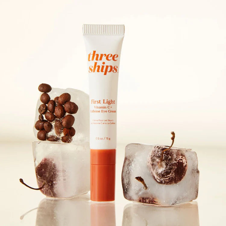Three Ships skincare product with ice cubes and berries on a light background