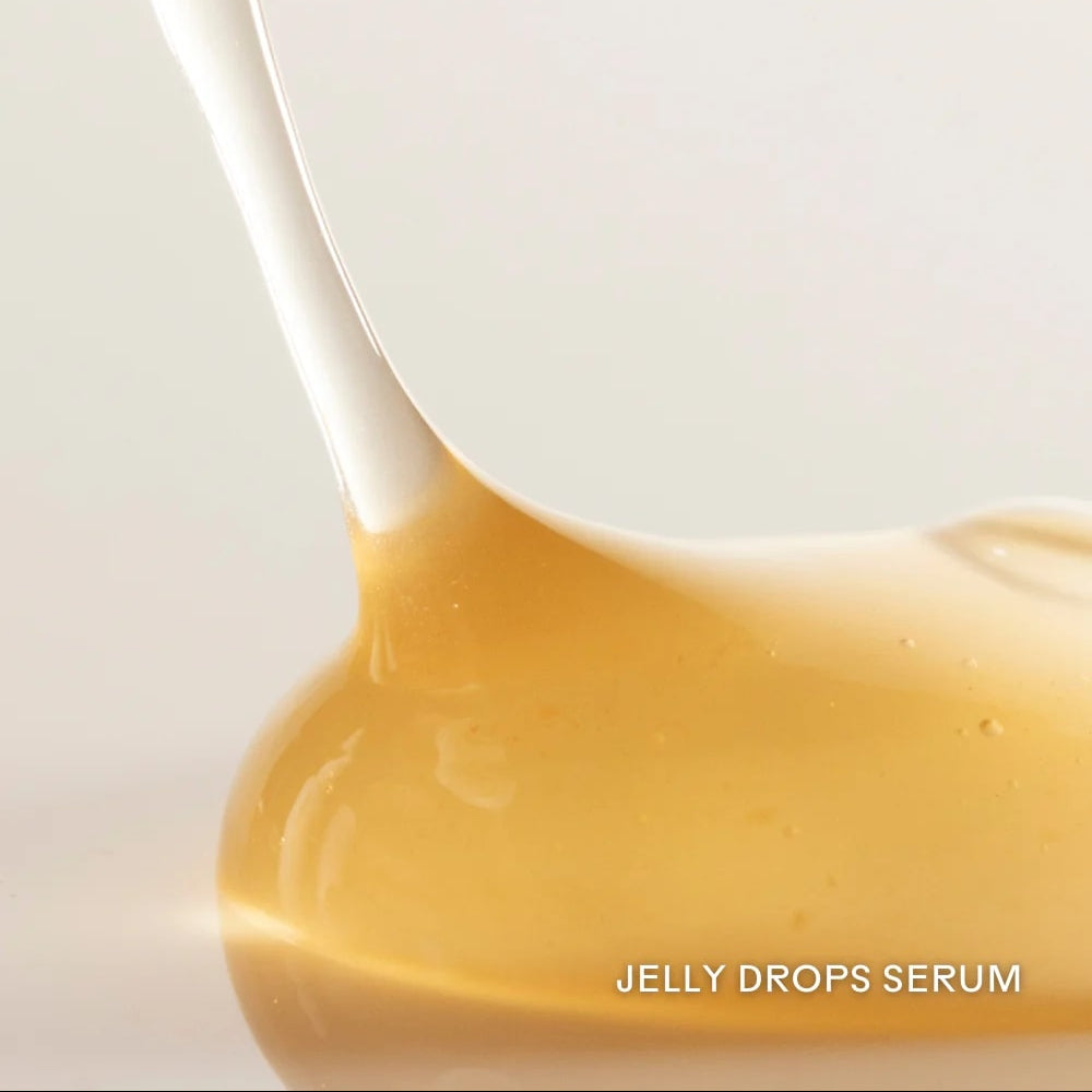 Close-up of jelly drops serum being poured onto a white surface with 'Jelly Drops Serum' text.