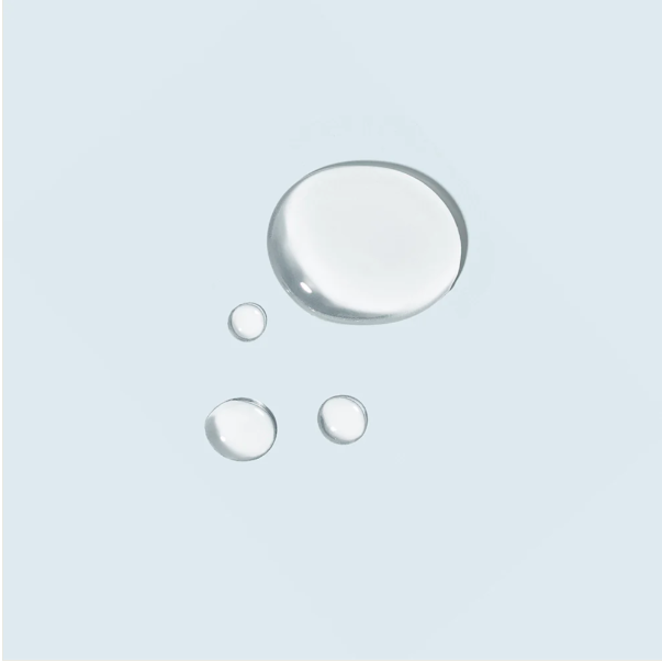 Four clear water droplets on a light gray background
