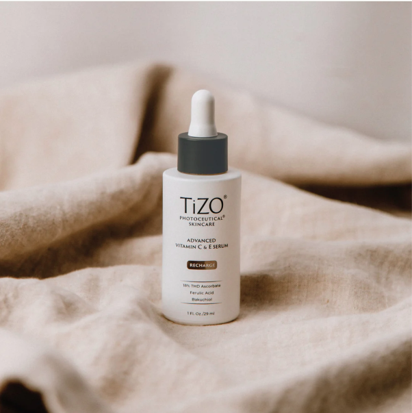 Tizo skincare serum bottle on a beige fabric background