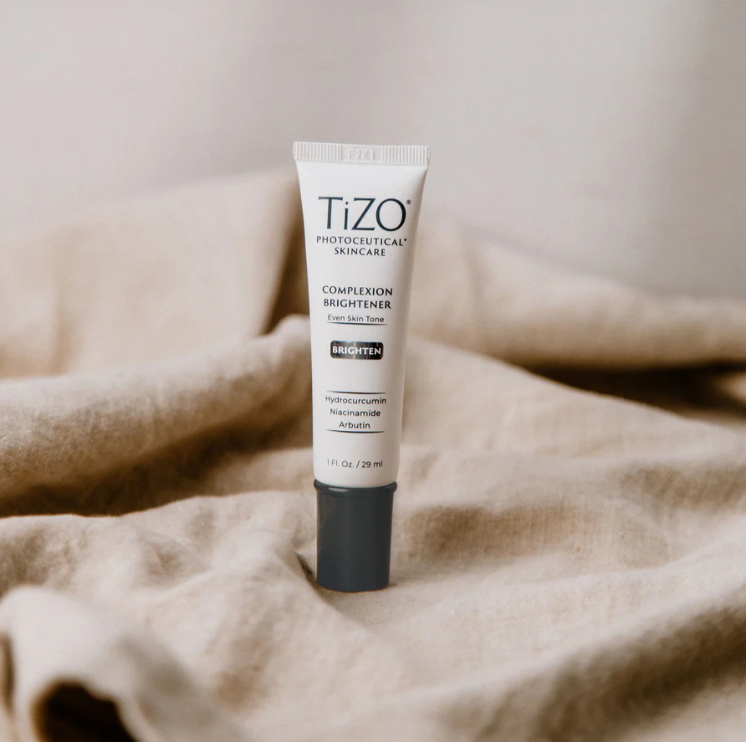 Tizo skincare tube on a textured beige surface