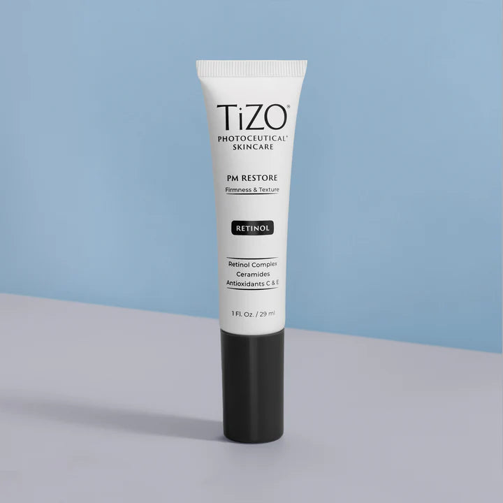 Tizo skincare tube on a gray surface with a light blue background