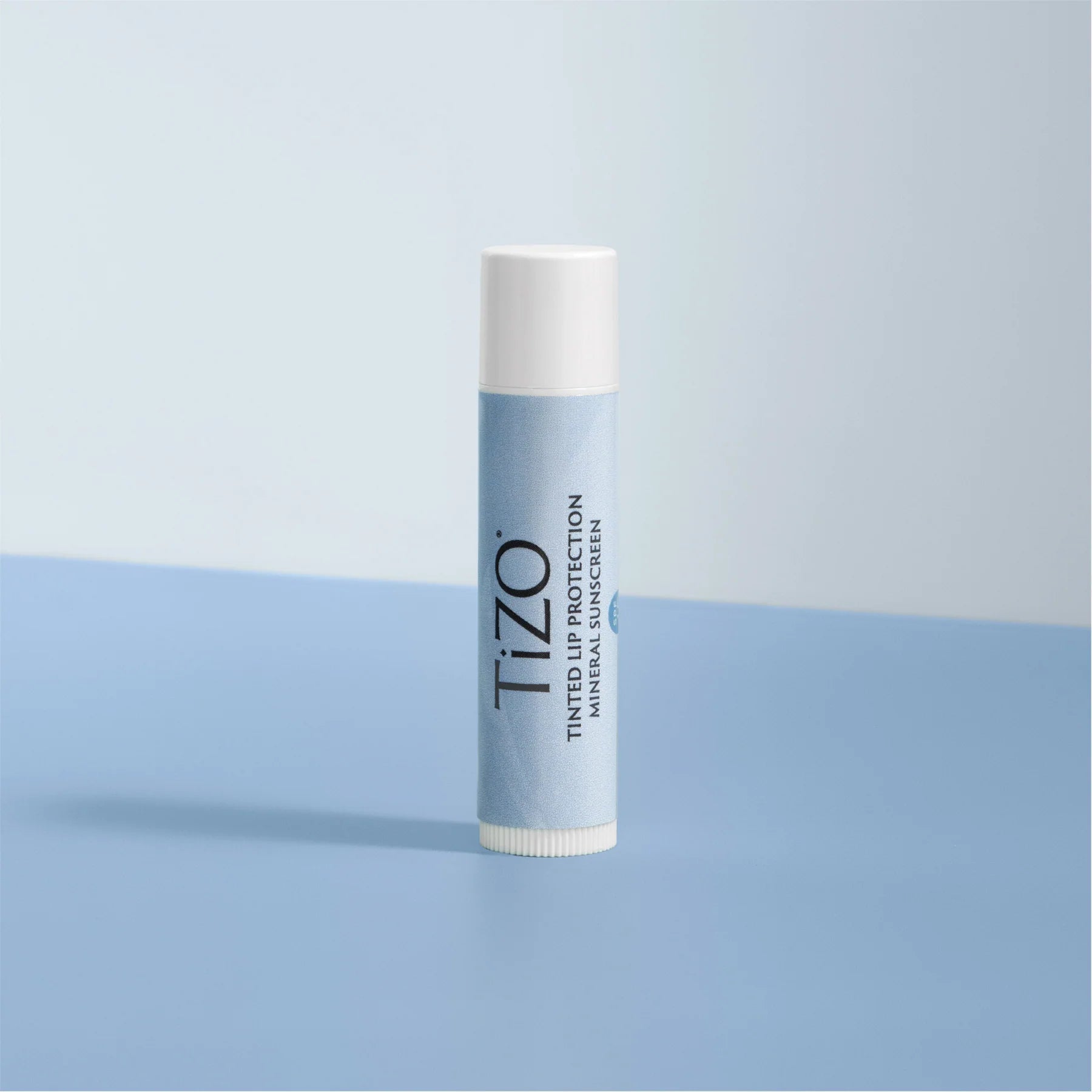 Tizo lip balm on a light blue background