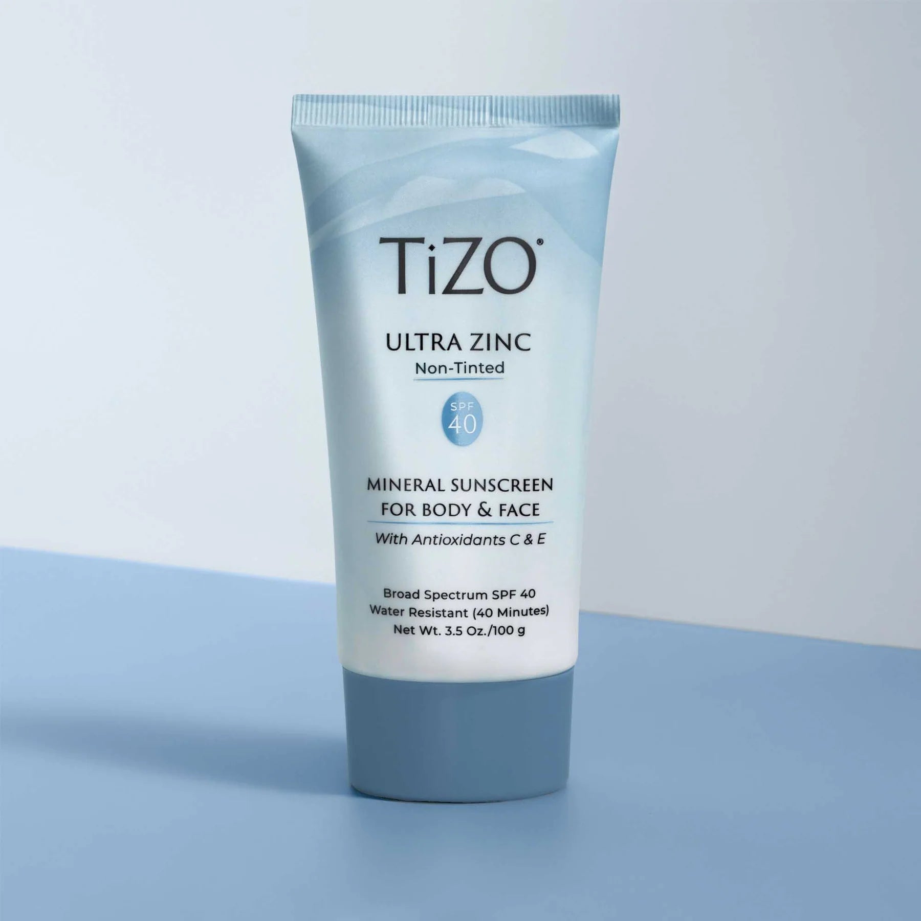 Tizo Ultra Zinc sunscreen tube on a light blue background