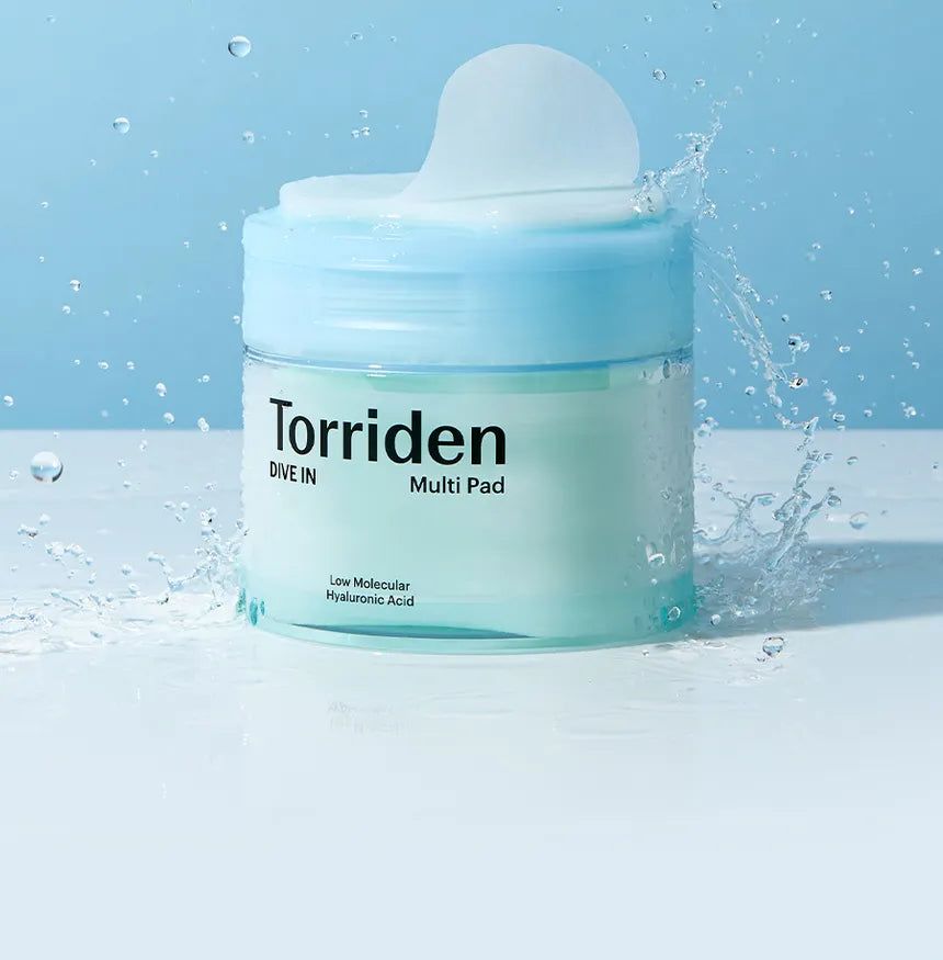 Torriden Multi Pad jar with water droplets on a blue background
