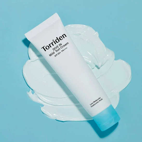 Torriden Dive In Mild Sun Cream tube on a light blue background