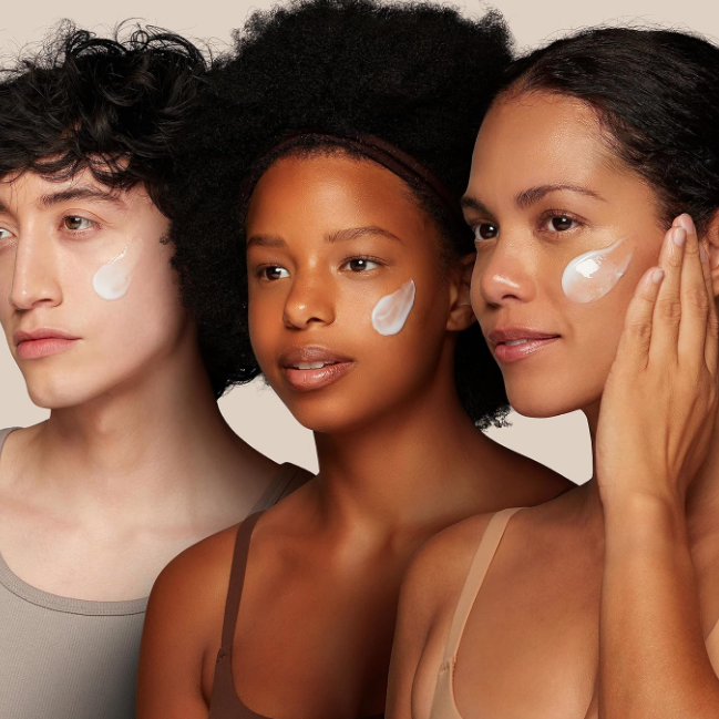 Three individuals with cosmetic products on their faces against a neutral background
