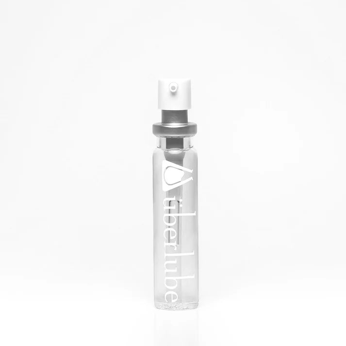 Two travel case inserts of überlube in a clear window box on a white background