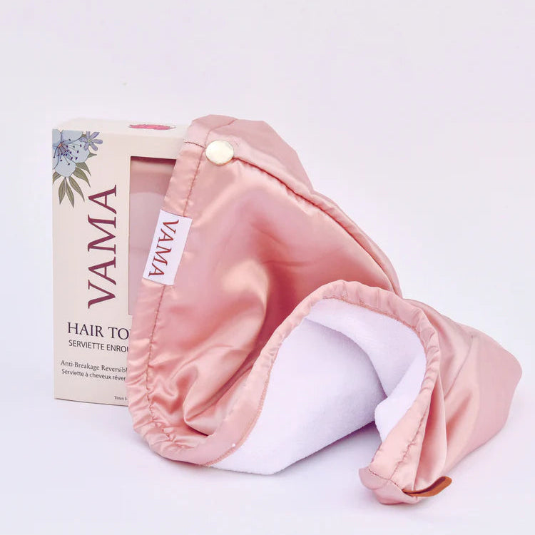 Pink hair towel with packaging labeled 'VAMA' on a light purple background