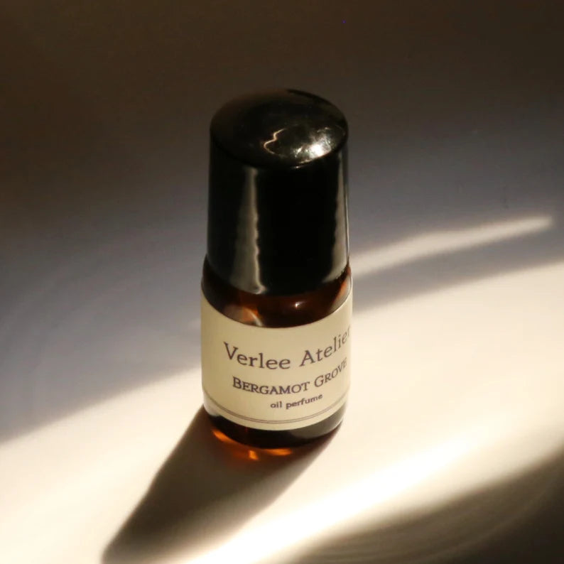 Small amber glass bottle with a white label on a reflective surface