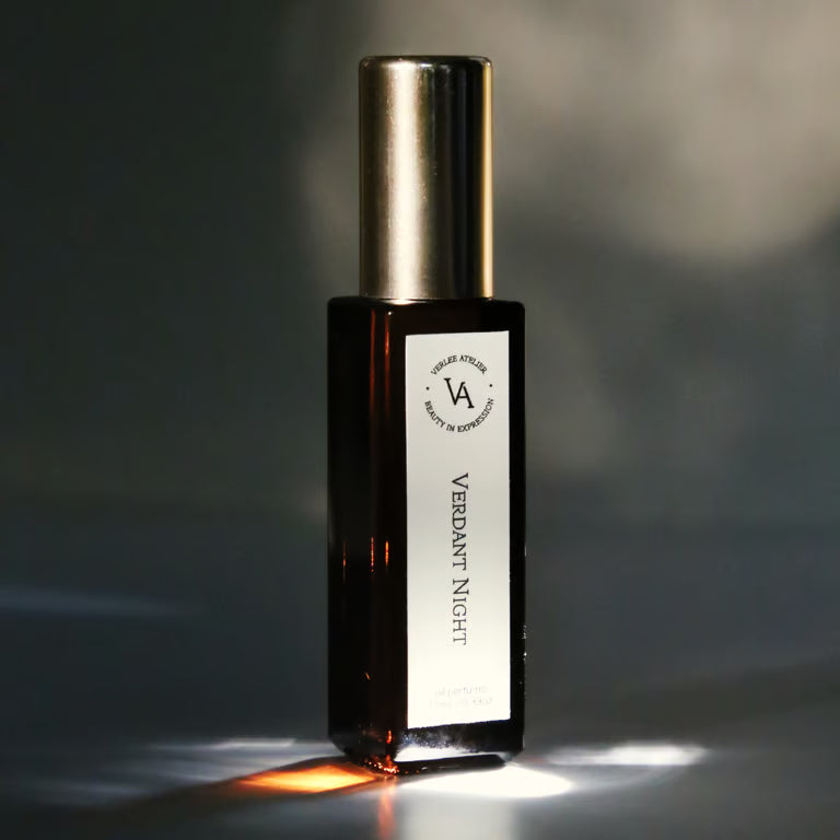 Perfume bottle labeled 'Verdant Night' with a dark background