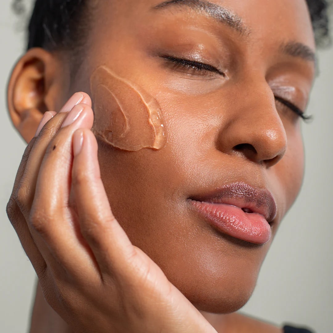 Woman applying a skincare product to her face