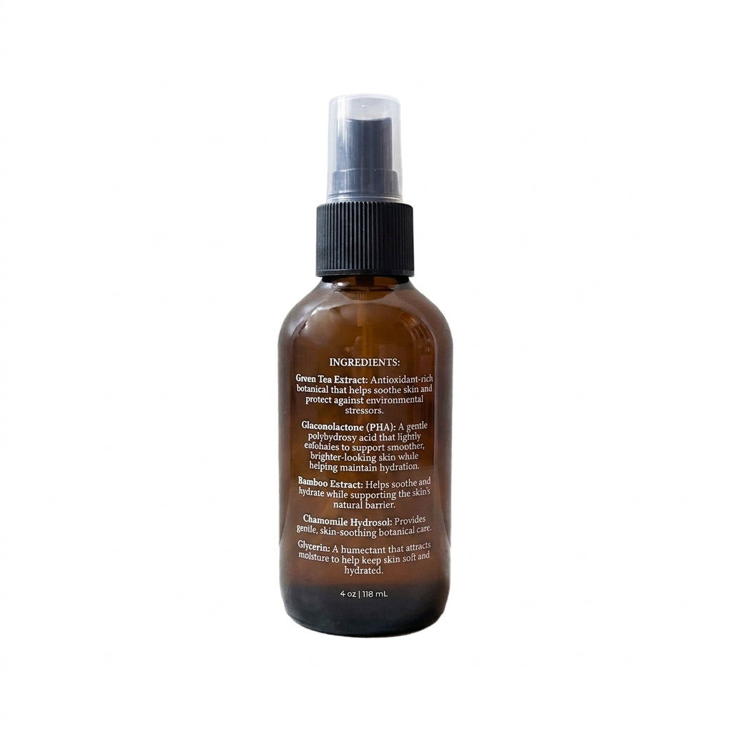 An amber glass spray bottle of Dewy Glow Hydration Mist with a black spray cap and white logo, centered on a plain white background.