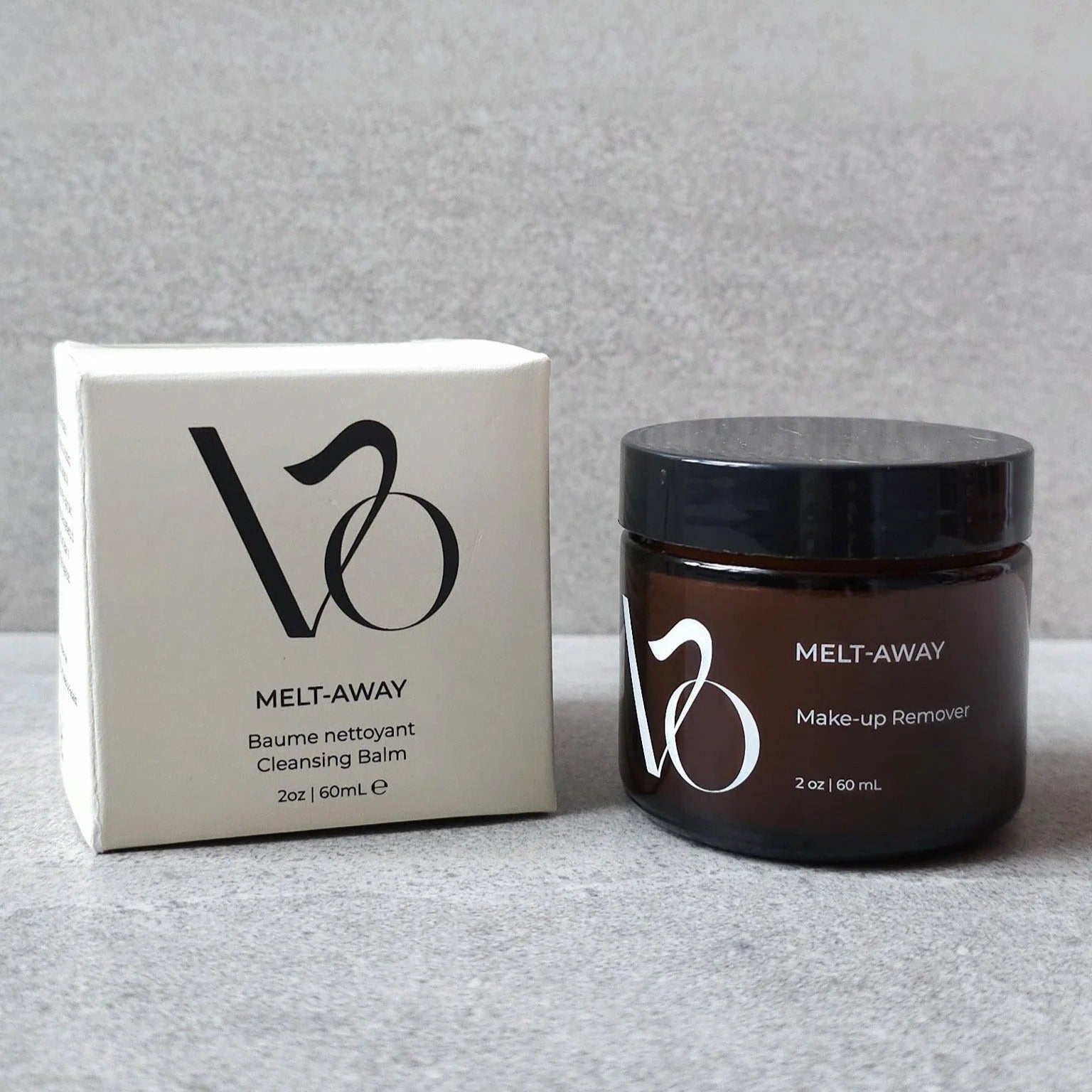 Make-up remover jar and box with brand logo on a gray background