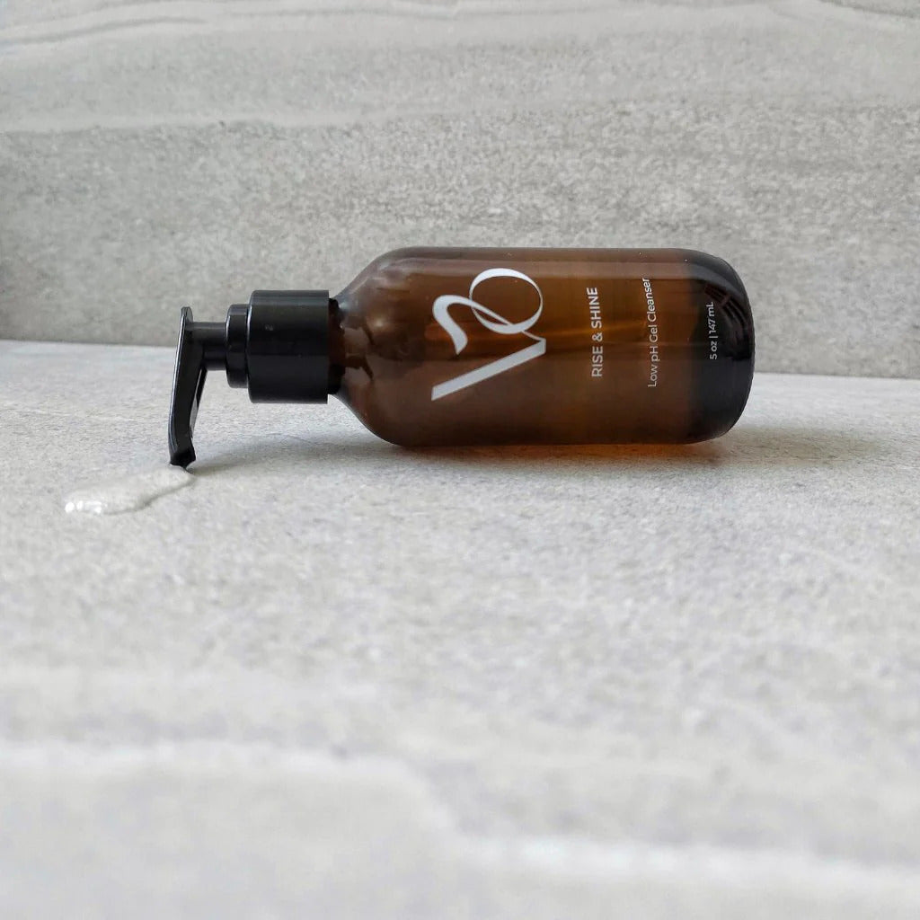 Brown bottle with pump on a textured surface